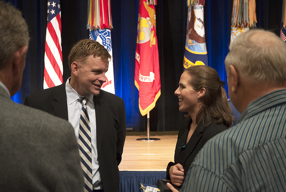 Audrey Goral speaks with a member of the Cooke family after receiving her award