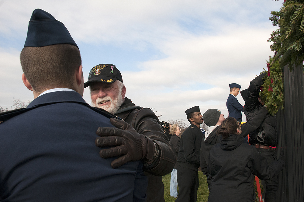 Volunteers thank and speak to each other after hanging wreaths up for Wreaths Across America