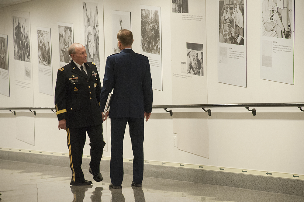 18th Chairman of the Joint Chiefs of Staff Army Gen. Martin E. Dempsey views the newly unveiled photo exhibit “National Memories” at the Pentagon
