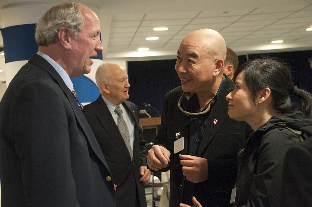Zhang Dongpan (right) speaks with a DoD fan about  an exhibit highlighting US-China military alliance during WWII