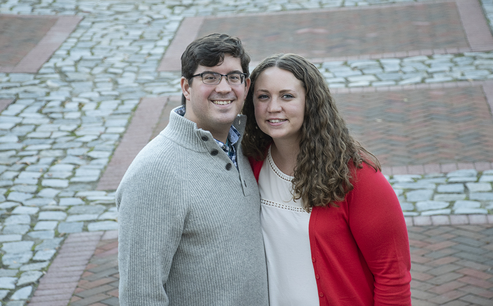 Newly engaged couple posing for a picture