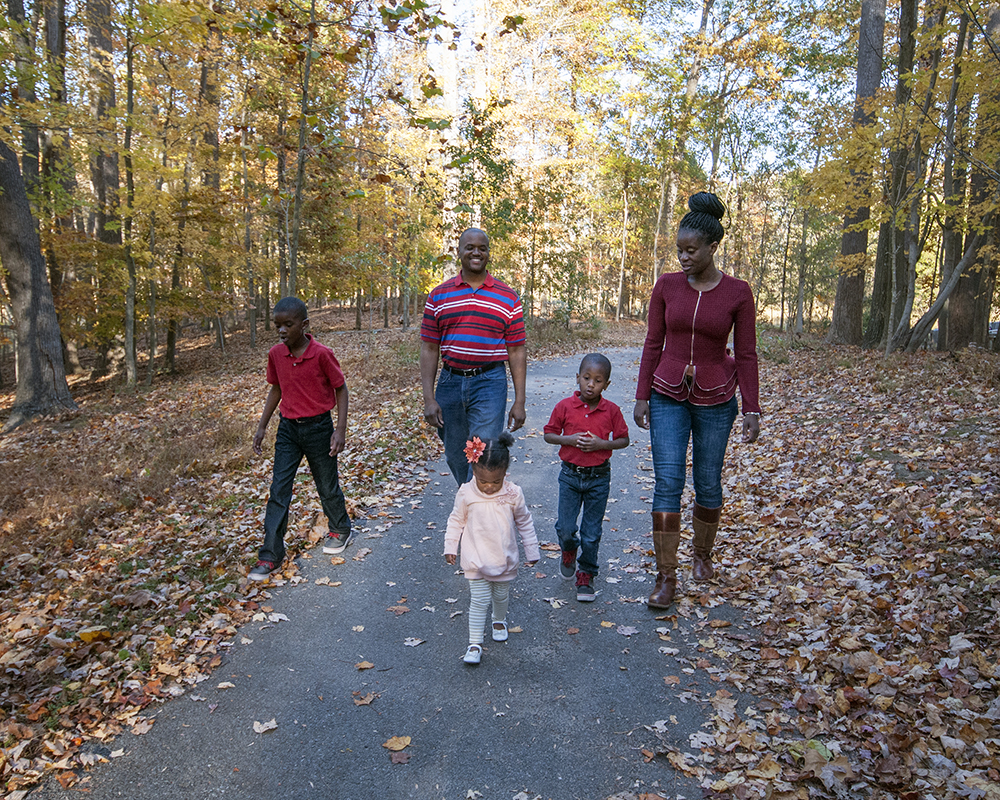 Family walking along path posing for a picture