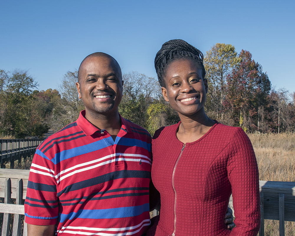 Husband and wife posing for a picture