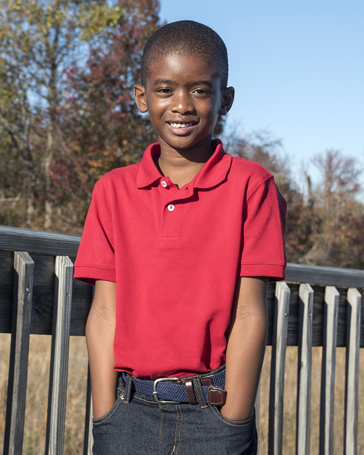 Young boy posing for a picture with hands in pocket