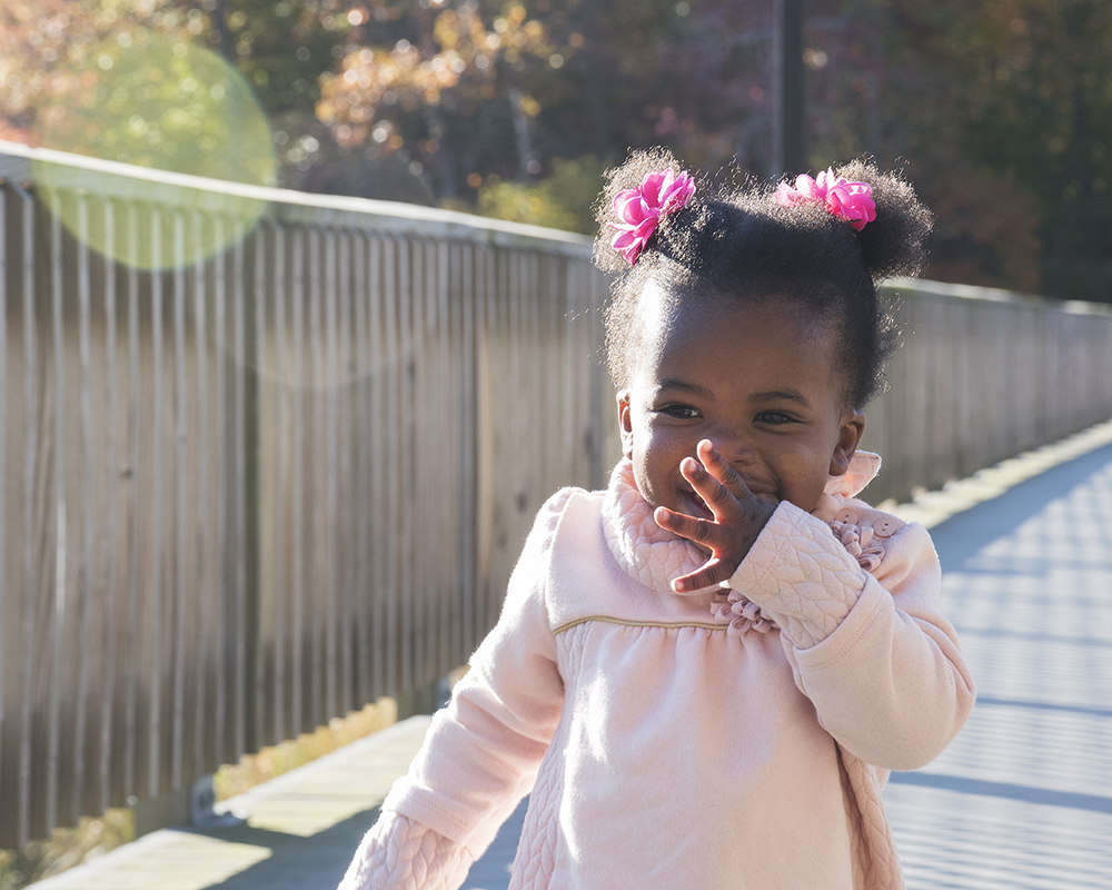 Young girl running and posing for a picture