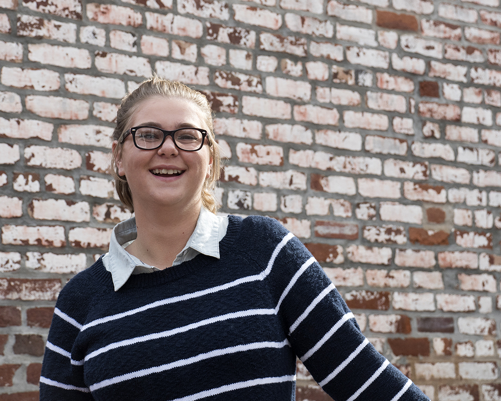 Young female posing for senior picture on location