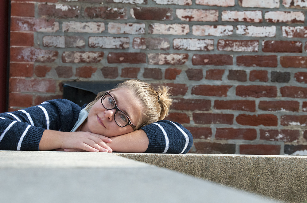 Young female posing for senior picture on location